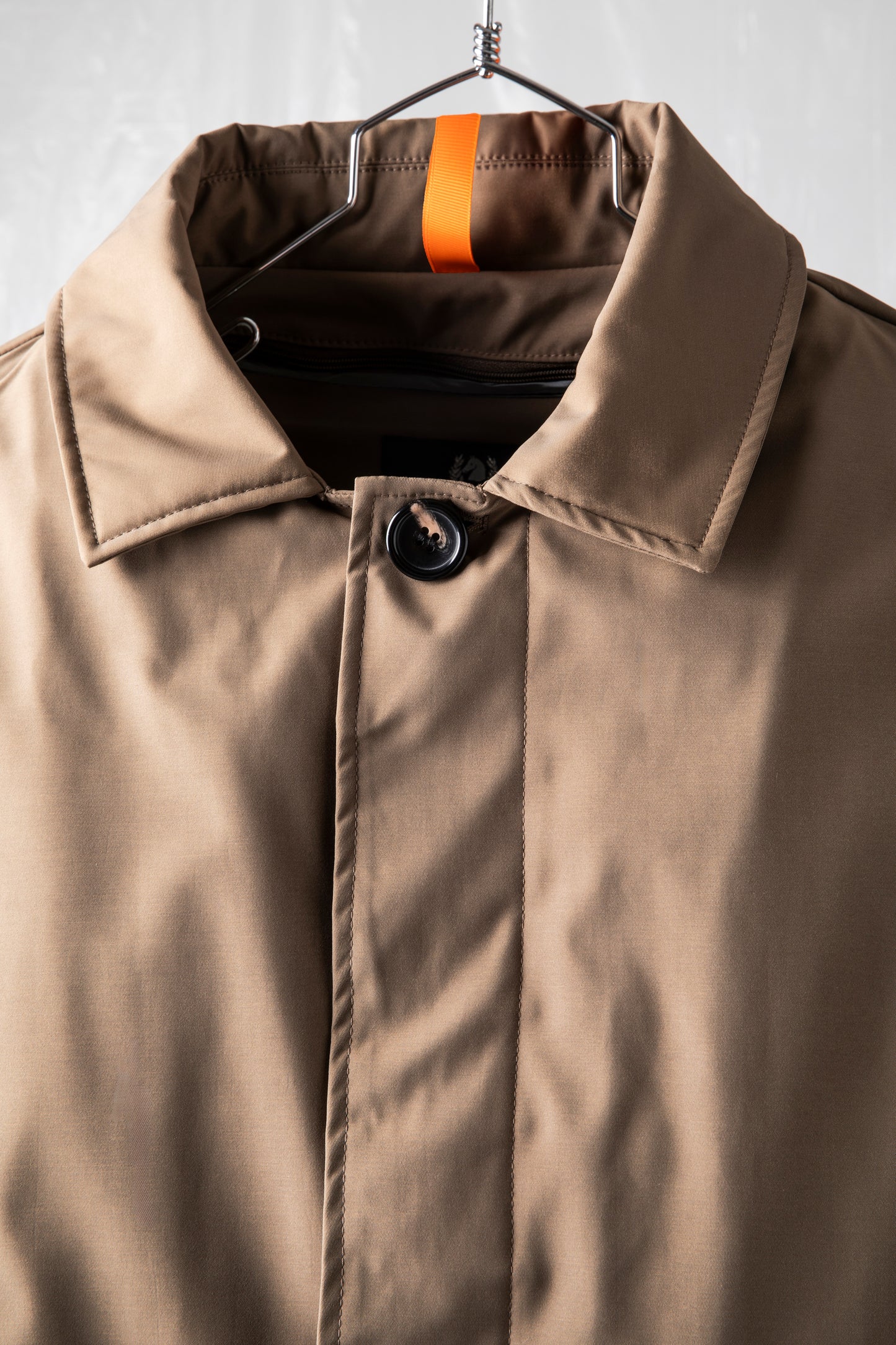 Technical coat with heat-sealed padding